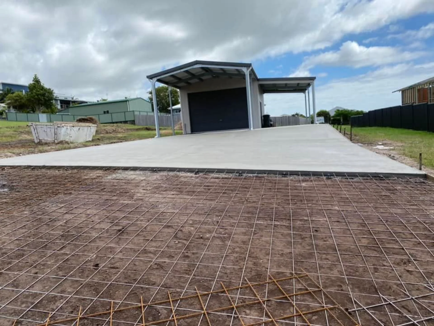 Steel reinforcement mesh and freshly poured concrete slab at a Hervey Bay shed