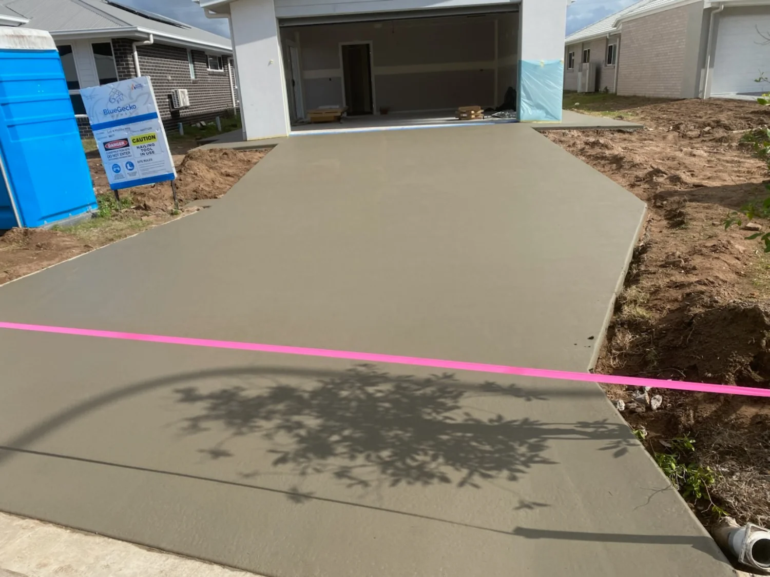 Freshly poured concrete driveway by Mark Holstein Concreting at a new residential property in Hervey Bay